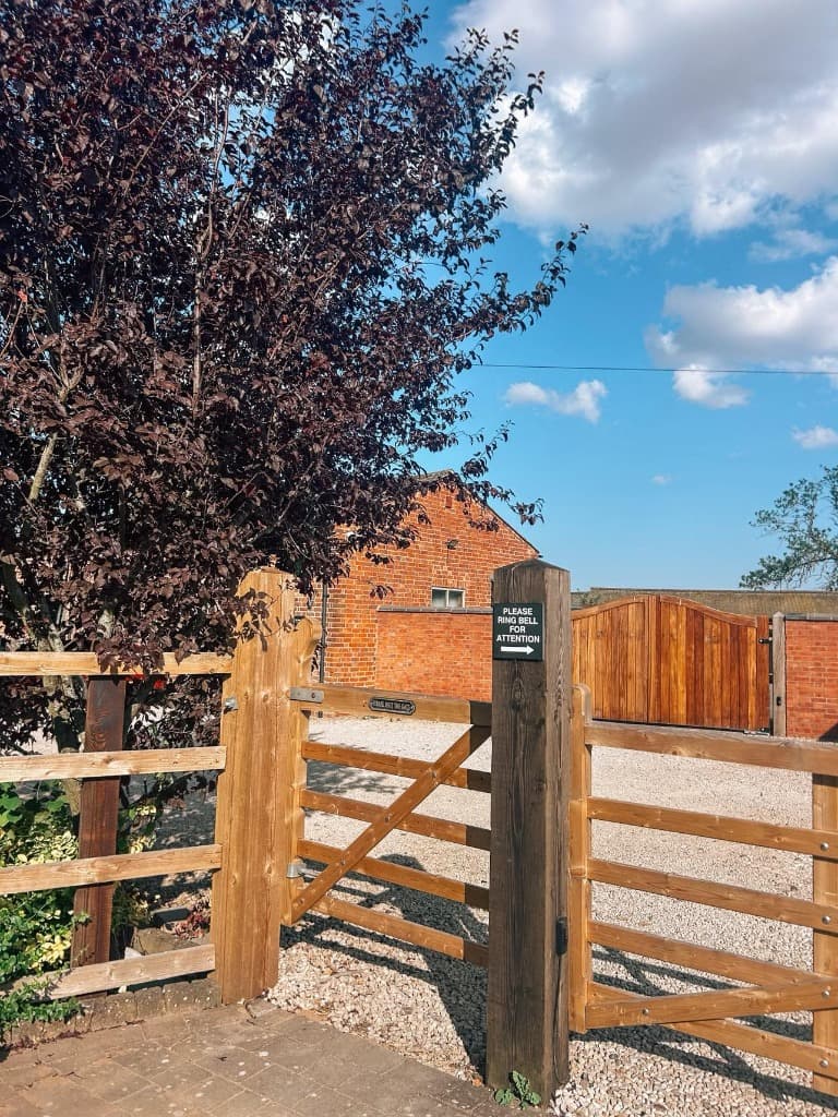 The Beauty Barn wooden gate entrance with please ring bell sign