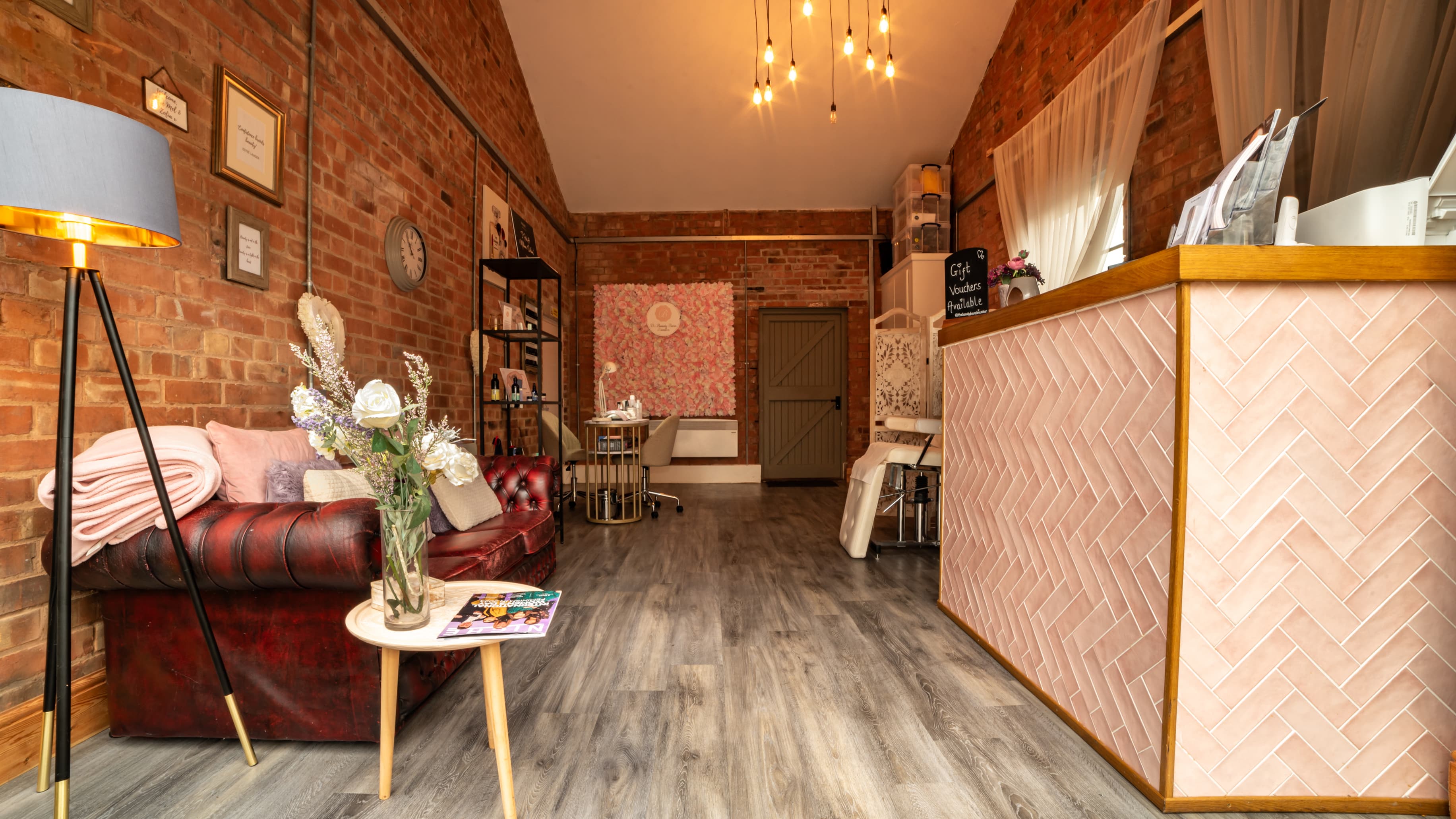 The Beauty Barn reception lounge with Chesterfield sofa and exposed brick