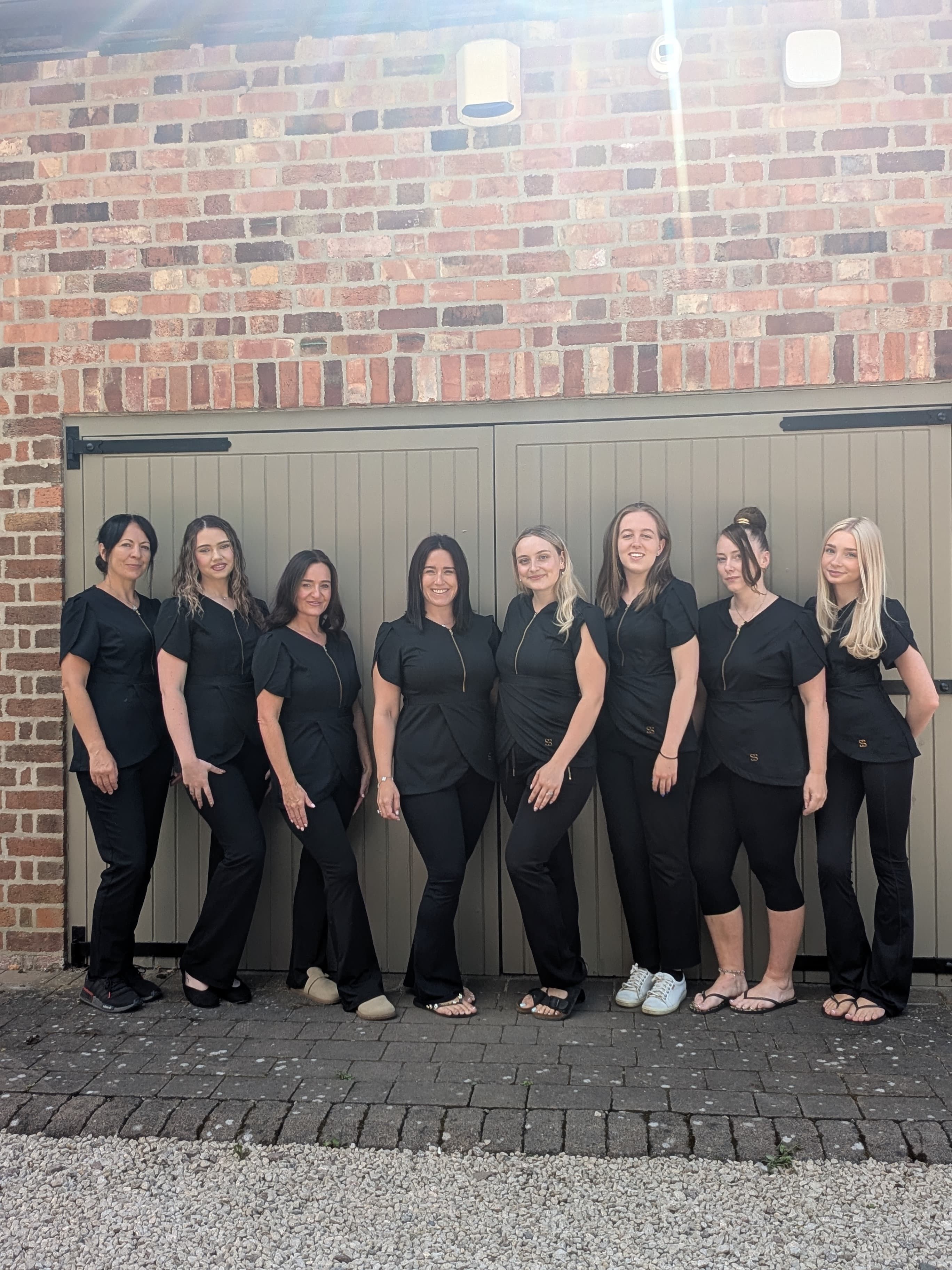 The Beauty Barn Leicester therapist team outside the garden cabin