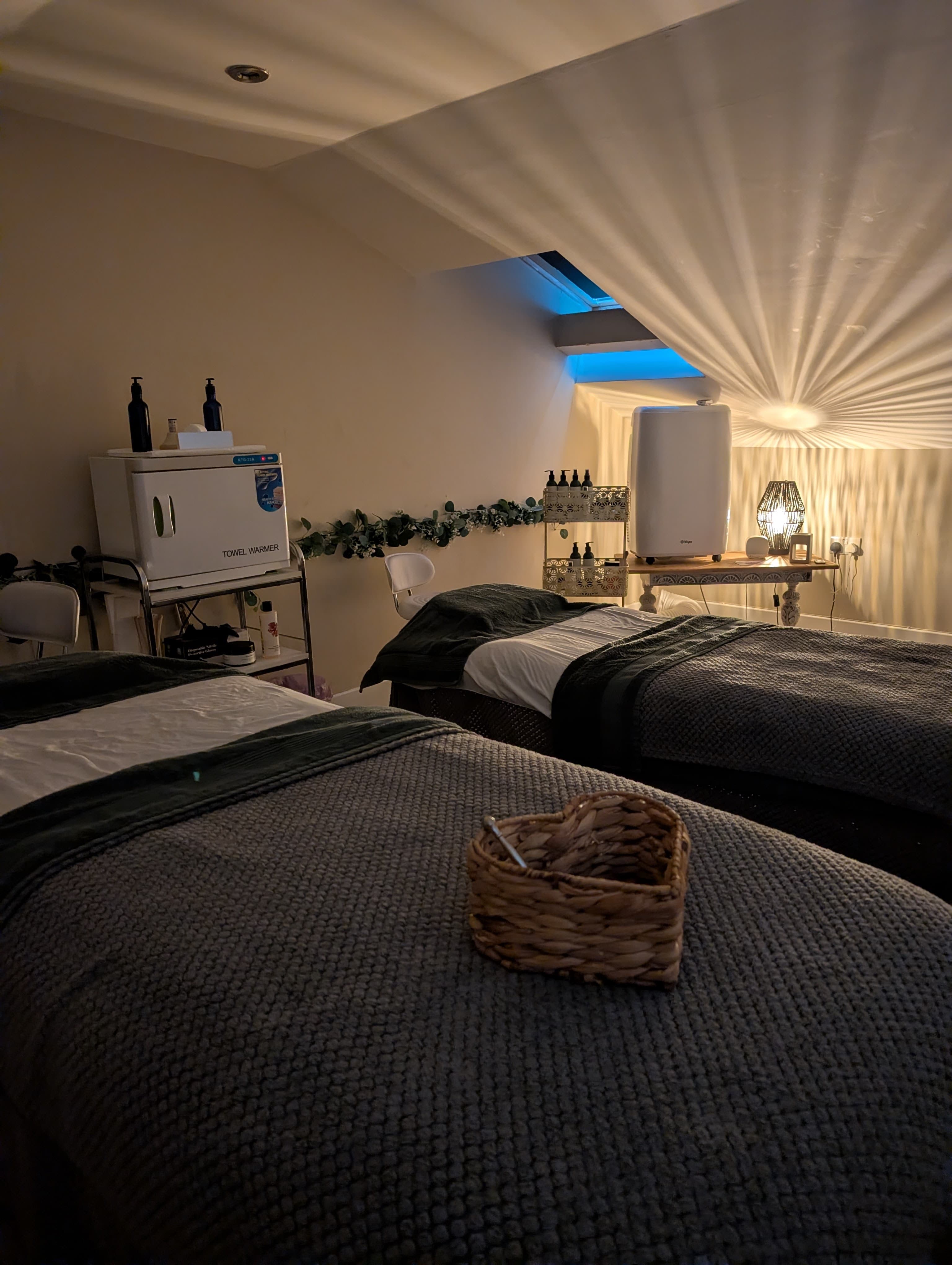 Couples massage room with twin beds and ambient lighting