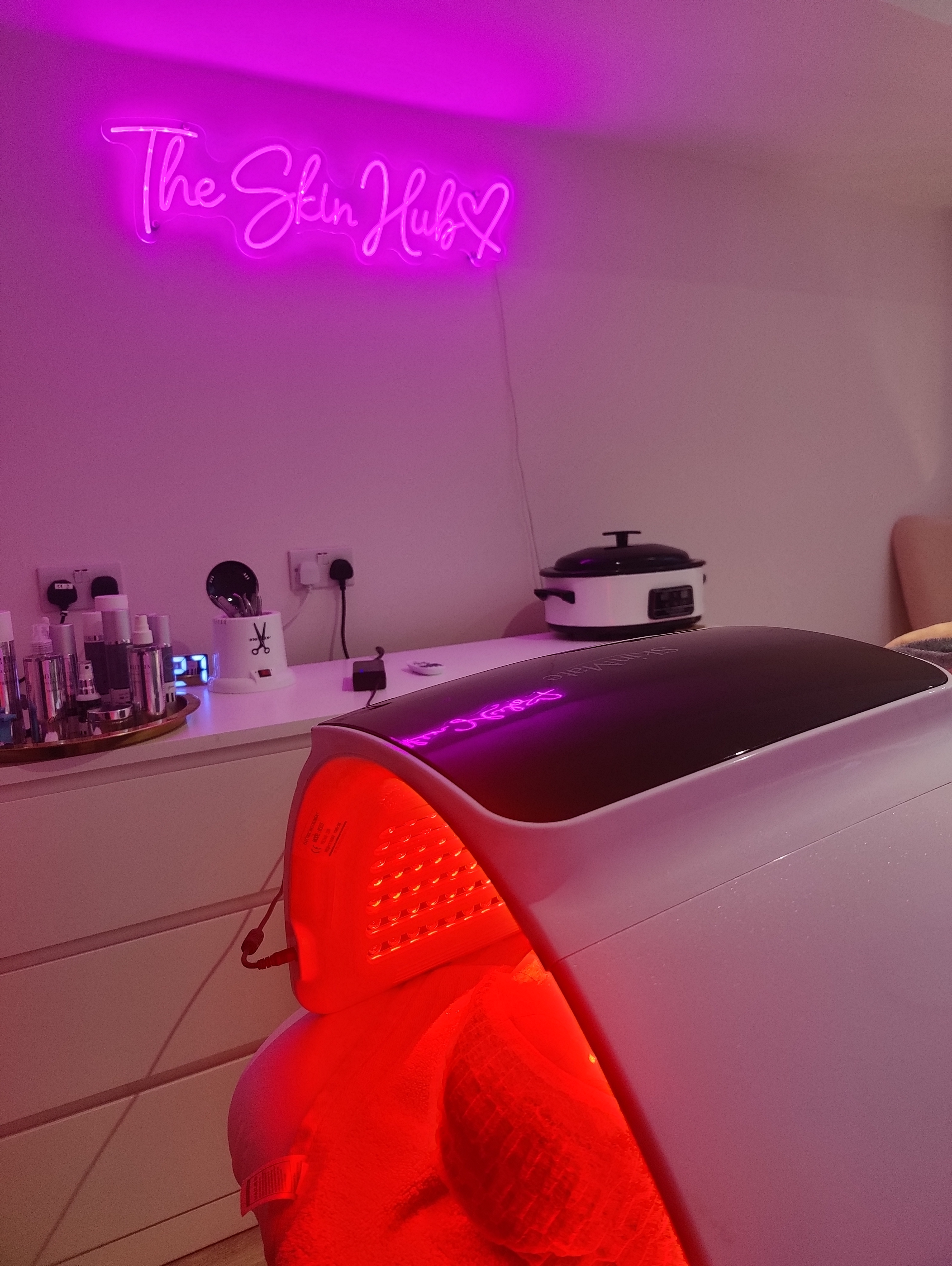 Clinical LED light therapy canopy arch glowing red in The Skin Hub