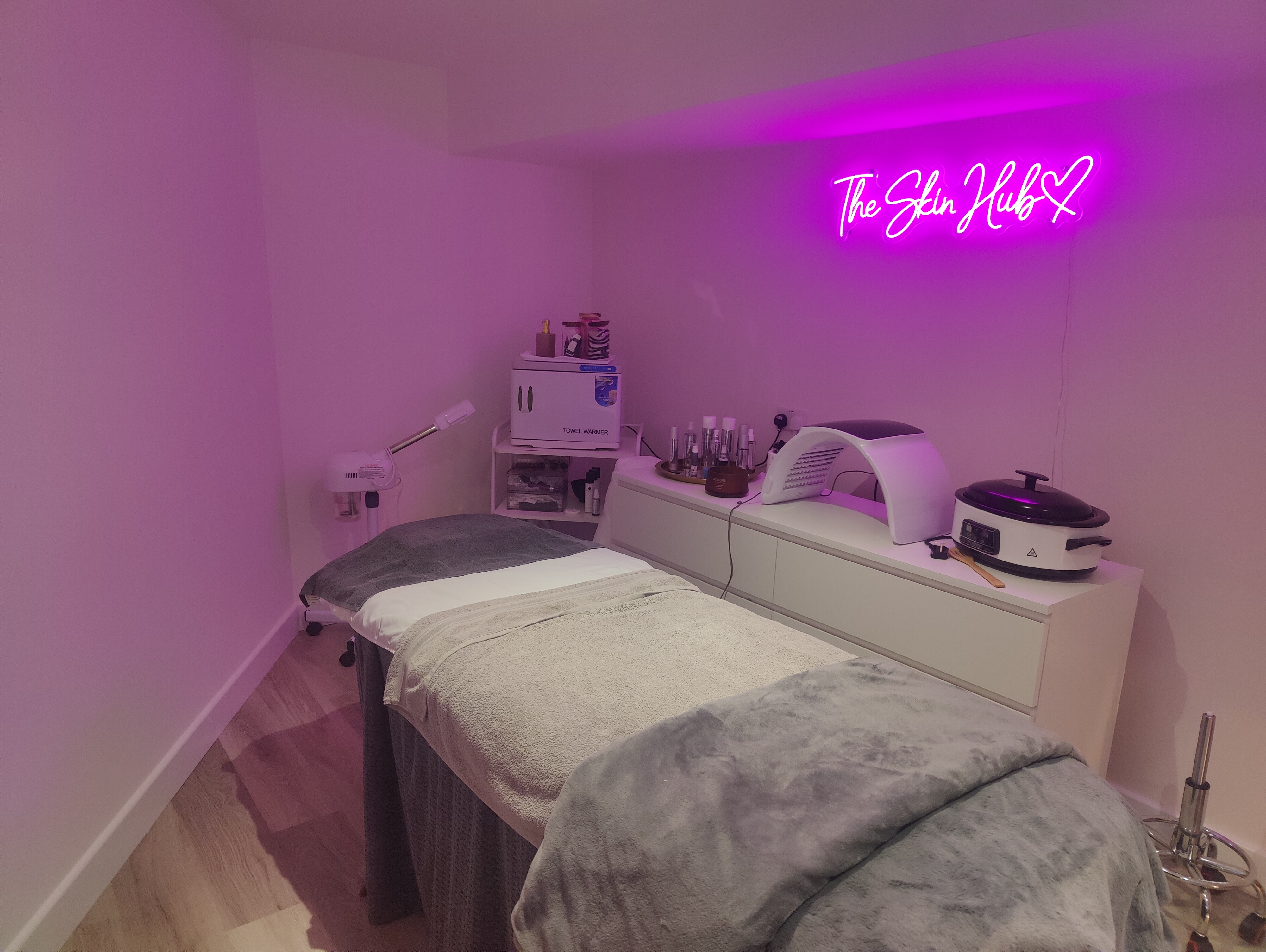 The Beauty Barn dedicated Skin Hub suite in Scraptoft with treatment bed and neon sign